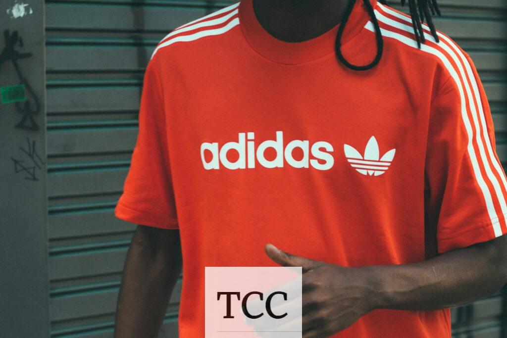 man wearing red and white adidas crew-neck T-shirt