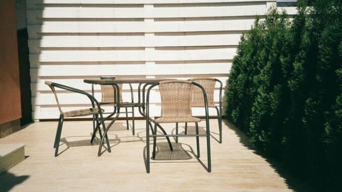 Photo by Vlad Bucur black metal framed white wooden table and chairs